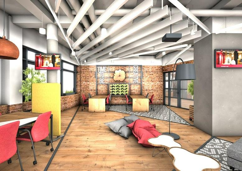 Vibrant lounge area at Adgar BIT, Konstruktorska 11, featuring bean bags and exposed ceiling pipes.