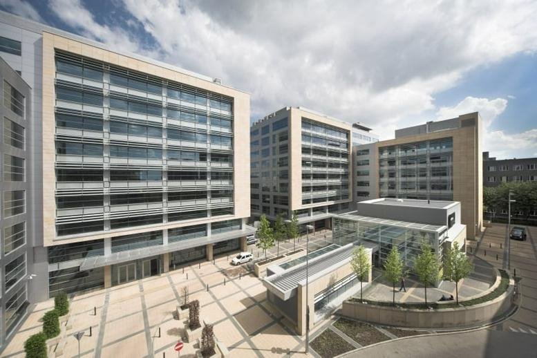 Wide exterior view of the modern glass and stone facade of Adgar Plaza A.