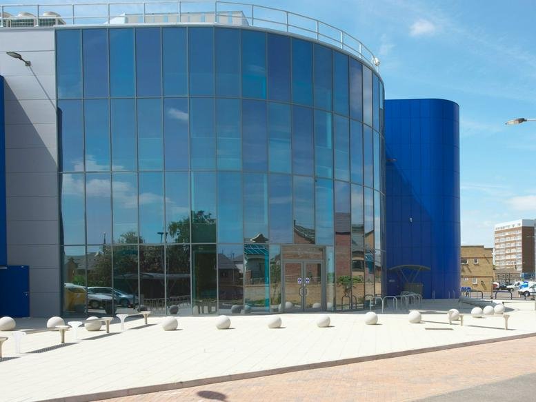 Exterior view of the curved glass facade at Allia Future Business Centre, Peterborough United Football Ground.
