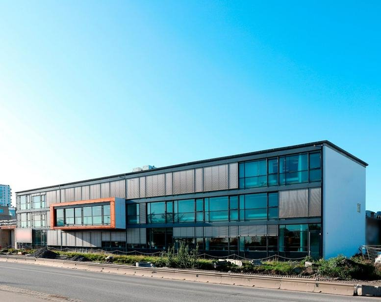 Exterior view of the modern glass and steel building at Amager Strandvej 60, Copenhagen.