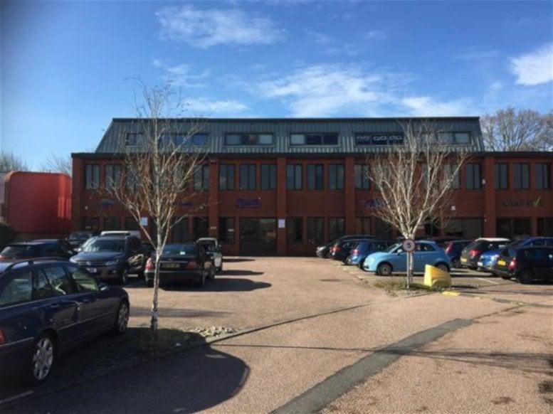 Exterior view of the brick facade and parking area at Amberley Court, Whitworth Road, Crawley.