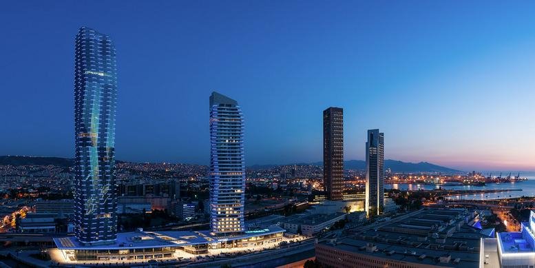 Exterior view of the soaring glass-facade Mistral Izmir towers at dusk.