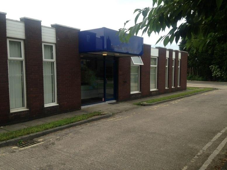 Exterior view of the brick facade and blue entrance canopy at Archbold House, Albert Road, Morley.