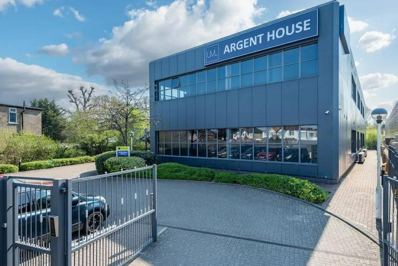 Exterior view of the modern two-story facade at Argent House with large glass windows.