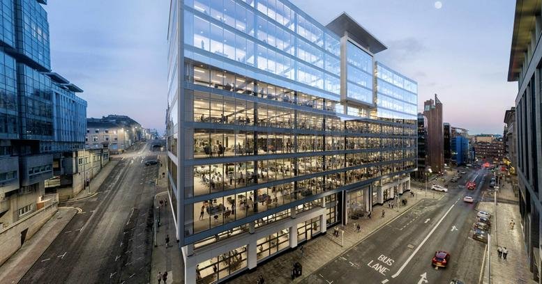 Exterior view of the glass-facade Aurora building at 120 Bothwell Street at dusk.