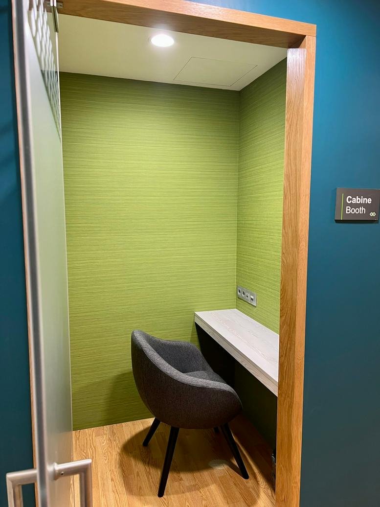 Small private phone booth with chair and desk