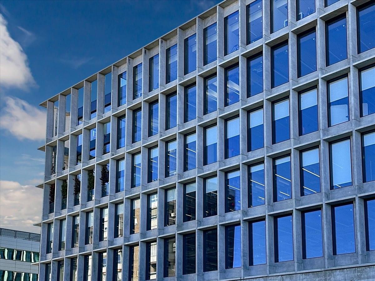 Exterior view of the modern grid facade at Avenida de Manoteras 12, Madrid.