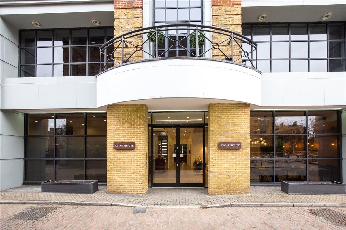 Exterior entrance of Avon House Avonmore Road with stone pillars and a white balcony.