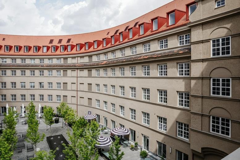 Exterior view of the curved facade and courtyard at Bahnhofsplatz, Nuremberg, Bavaria.