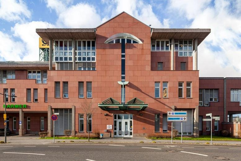 Red brick exterior of Bahnhofstraße 82-86, Giessen, Hesse with modern architectural details.