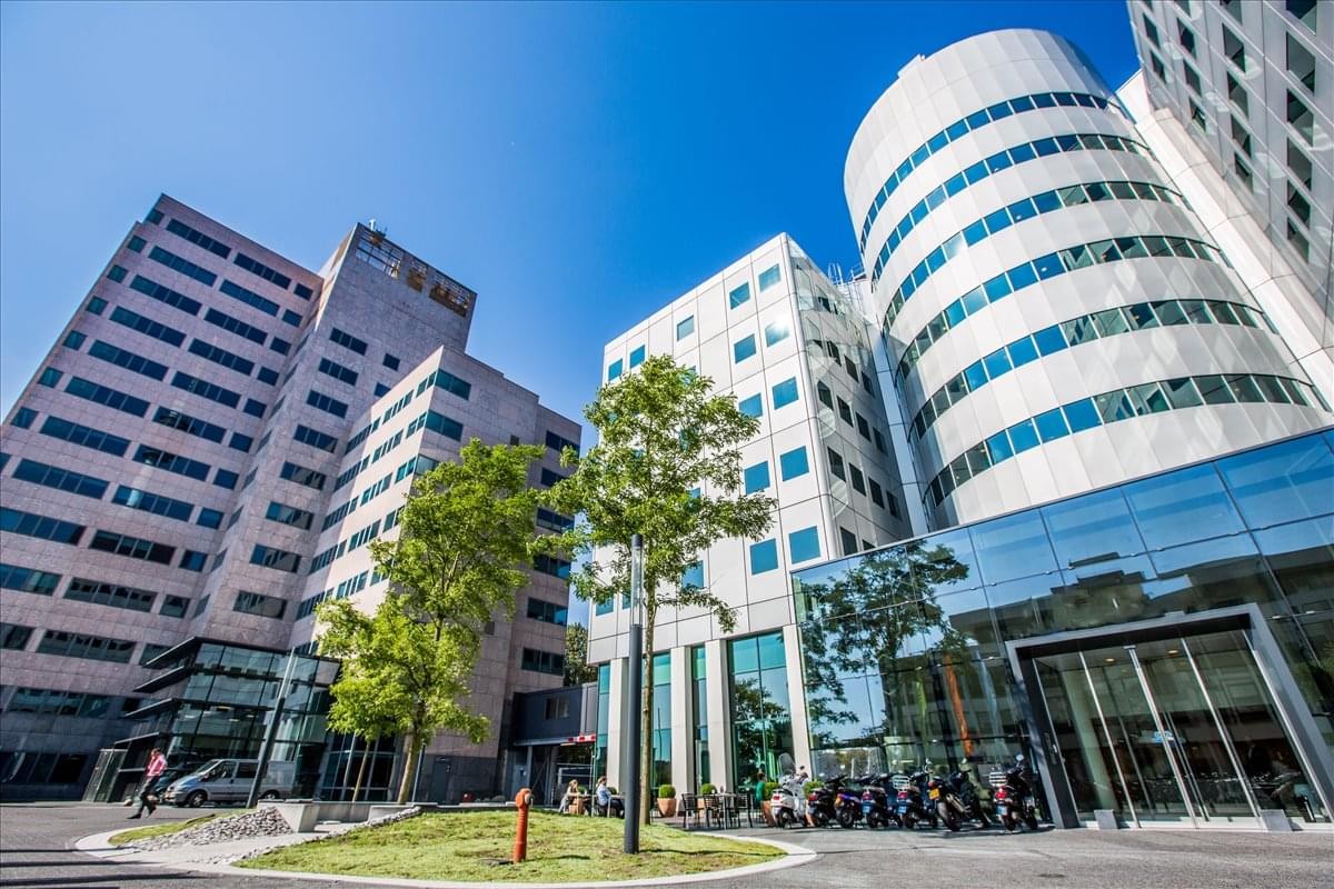 Exterior of the modern glass and stone building at Barbara Strozzilaan 201.