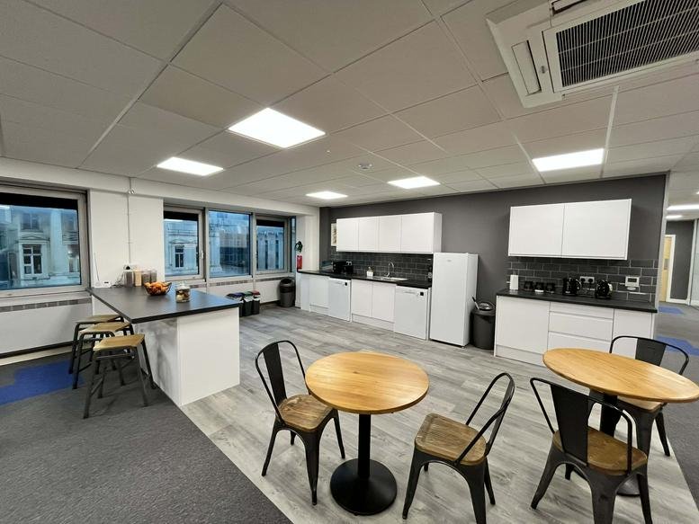 Spacious breakout area at Bartholomew Square, Barts House with kitchen facilities and dining tables.
