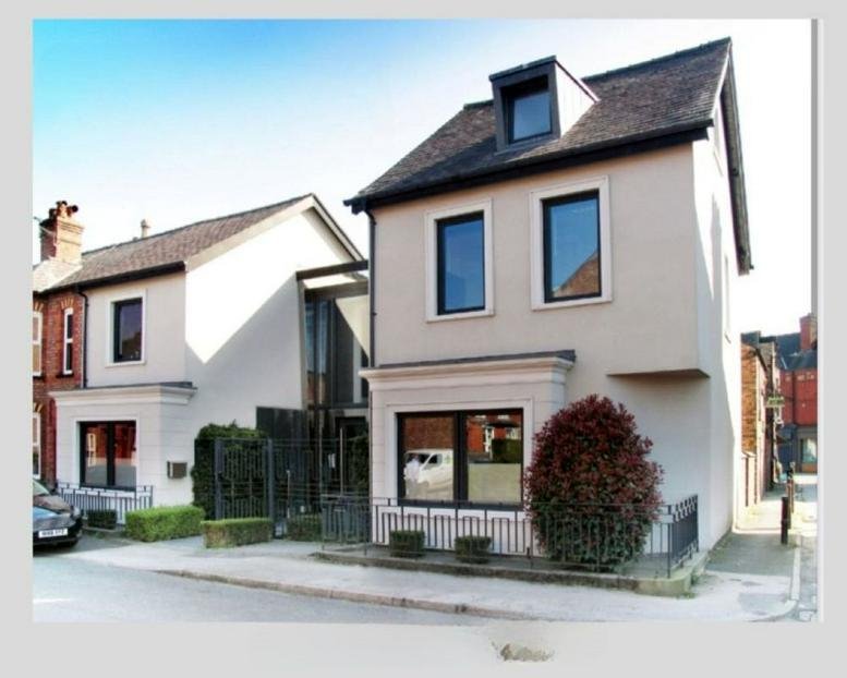 Exterior view of the light-colored residential-style building on Bath Street, Hale, Altrincham.