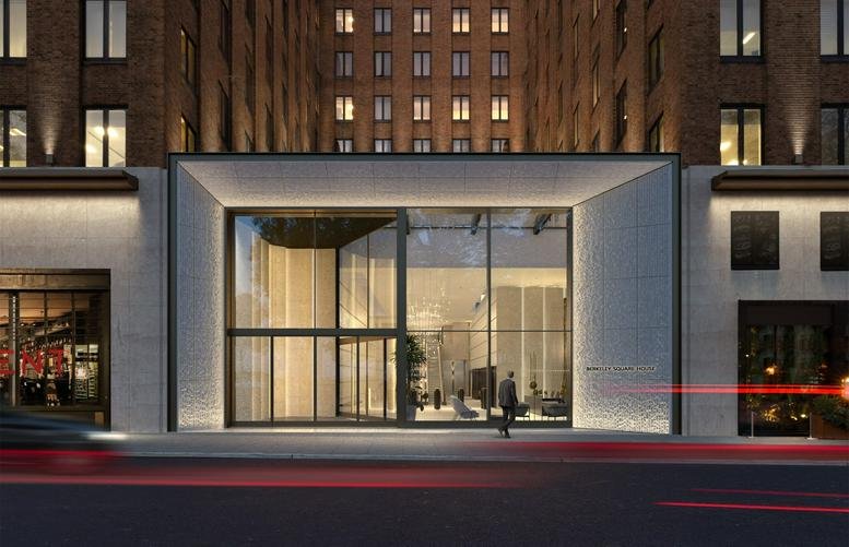 Modern glass storefront entrance of Berkeley Square House, London at dusk.