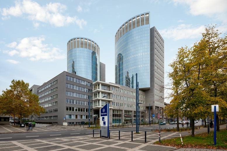Exterior view of the modern twin glass-tower building at Berliner Straße 114-116.