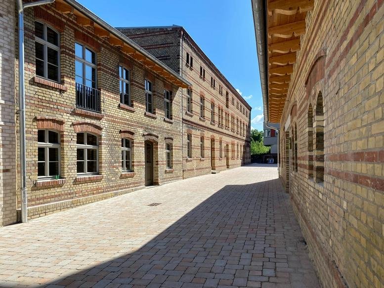 Exterior view of the historic brick industrial buildings at Berliner Strasse 80.