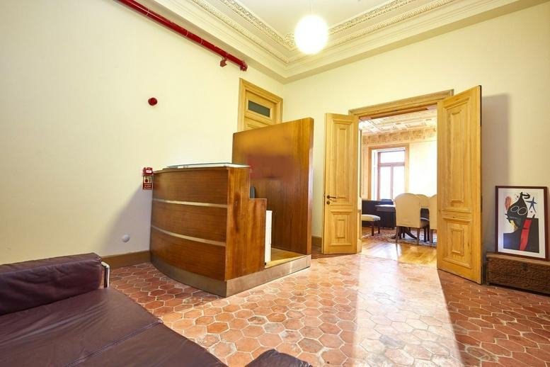 Reception area at Beyoglu, Hüseyinağa Mahallesi, İstiklal Cd, Kat: 3, No: 56/58, Daire: 5 with wooden desk and red accents.