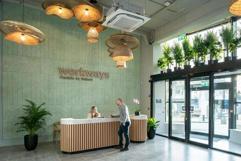 Reception area at Block 5, High Street featuring a green textured wall and woven pendant lights.