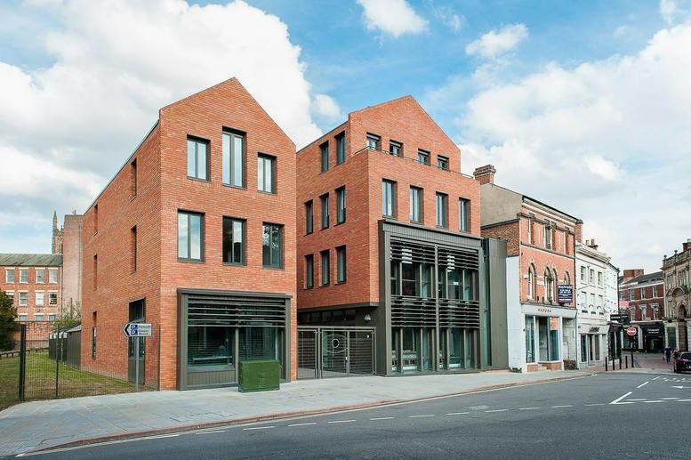 Exterior view of the contemporary red brick facade of Sadler Bridge Studios in Derby.