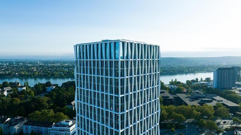 Exterior view of the high-rise Bonn Neuer Kanzlerplatz building against a blue sky.