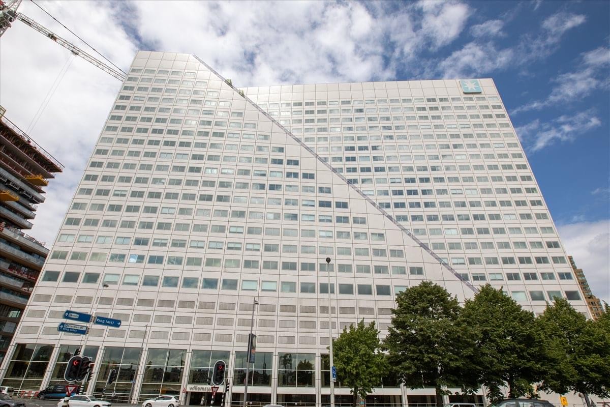 Exterior view of the white facade and unique architecture at Boompjes 40, Rotterdam.