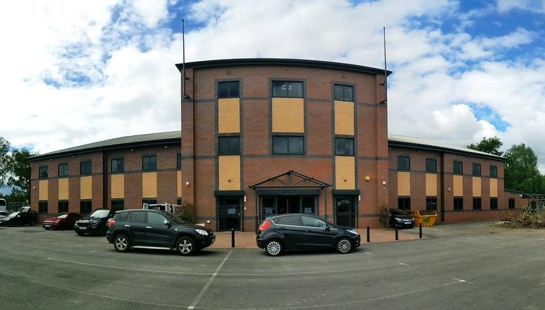 Exterior view of BP House, Skelton Grange Road with brick facade and parking.