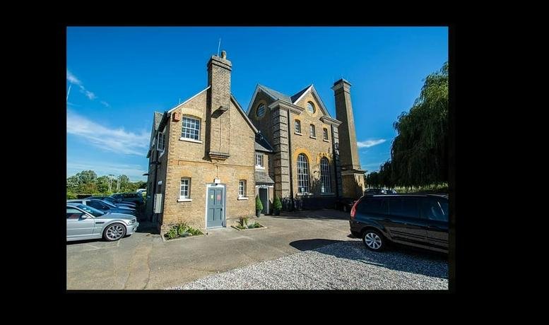 Exterior view of the historic brick Broadmeads pumping station, Hertford Road, Ware with a blue sky.