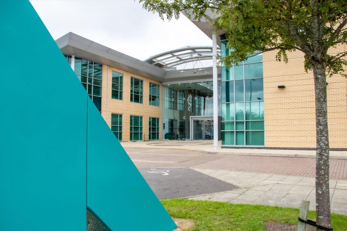 Modern glass and tan exterior facade of Merlin House on Brunel Road.