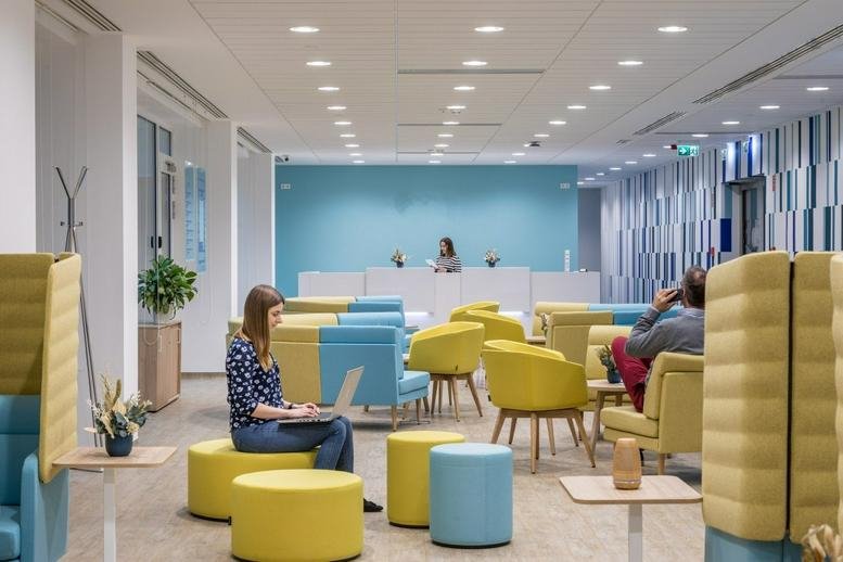 Spacious reception and lounge at BudaPart Gate, Dombovari Útca 27, Budapest with colourful yellow and blue seating.