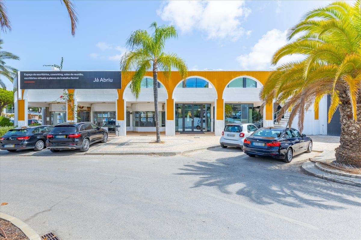 Exterior view of the Mediterranean-style Buganvilia Plaza 1 with arched windows and palm trees.