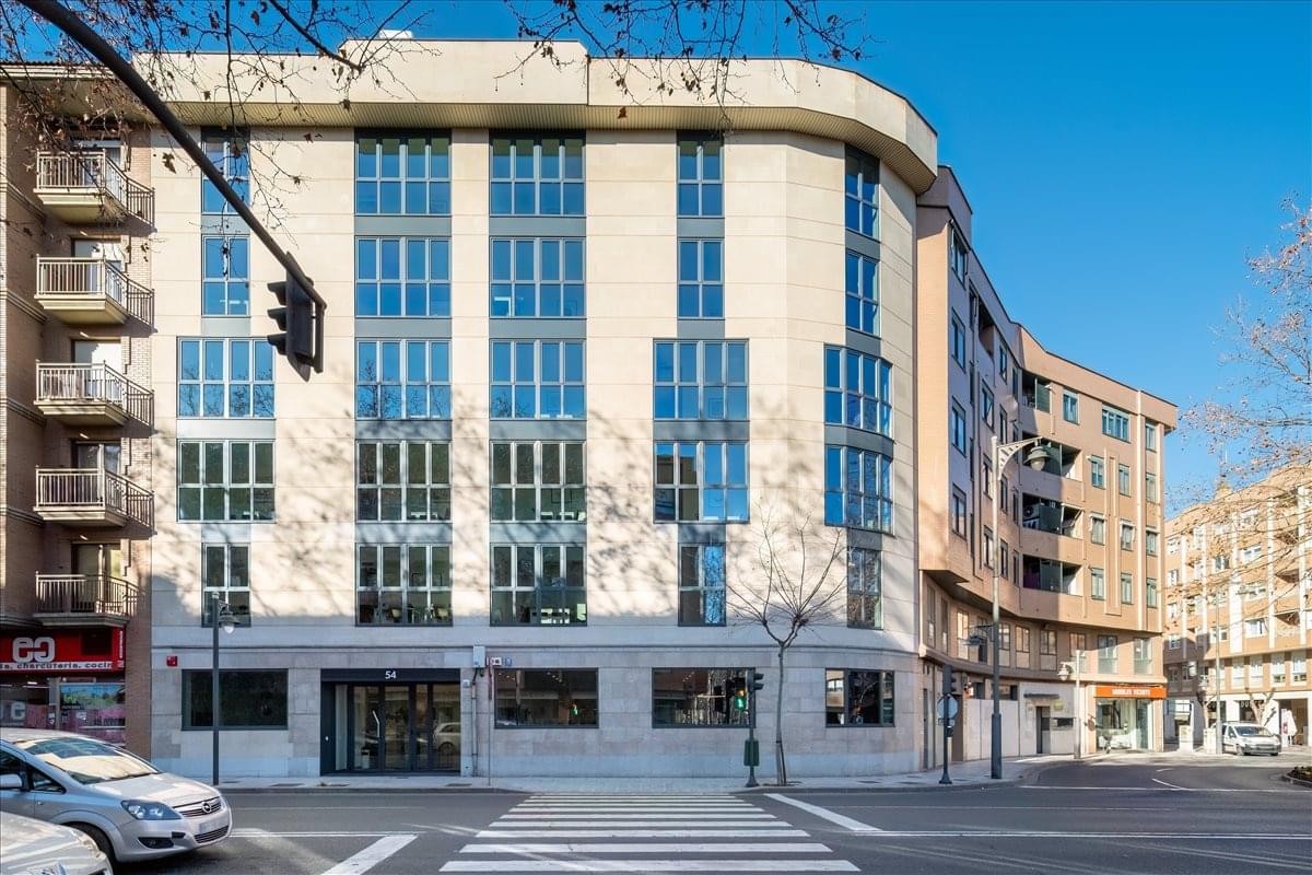 Exterior view of the modern light-colored stone building at Calle Chile 54, Logroño.