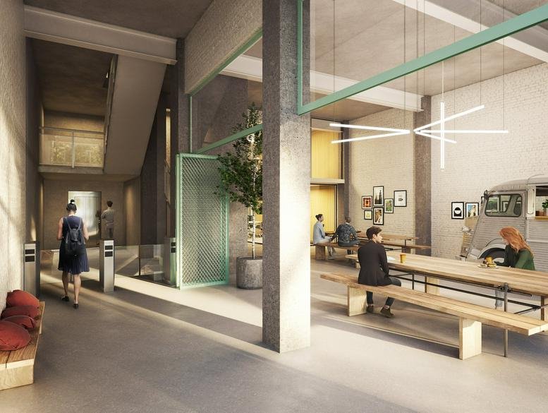 Modern reception lobby at Calle de Avila, 112, 22@ Glòries featuring industrial concrete and a wood-slat bench.