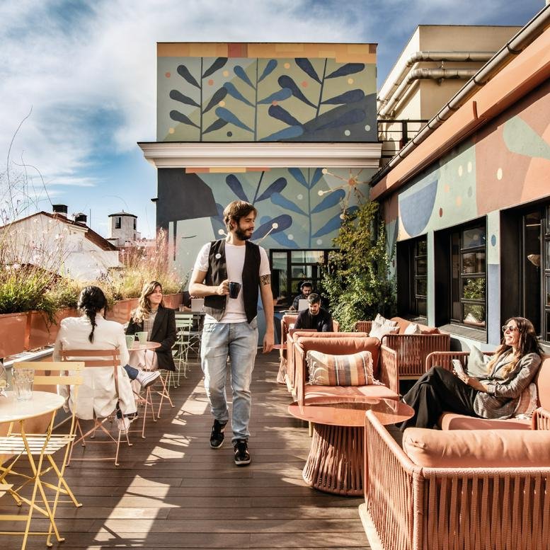 Expansive outdoor deck with stylish wooden seating and a large nature-inspired mural.