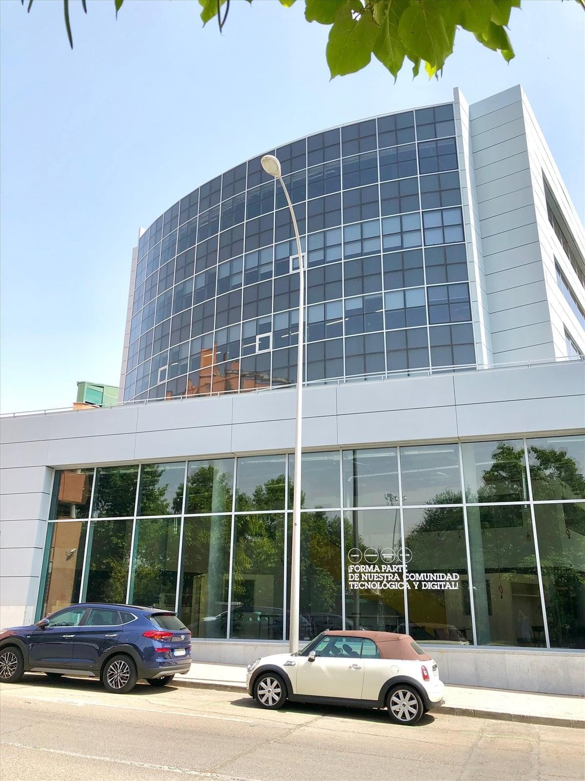 Exterior view of the modern glass and stone building at Calle Juan de Mariana 15.