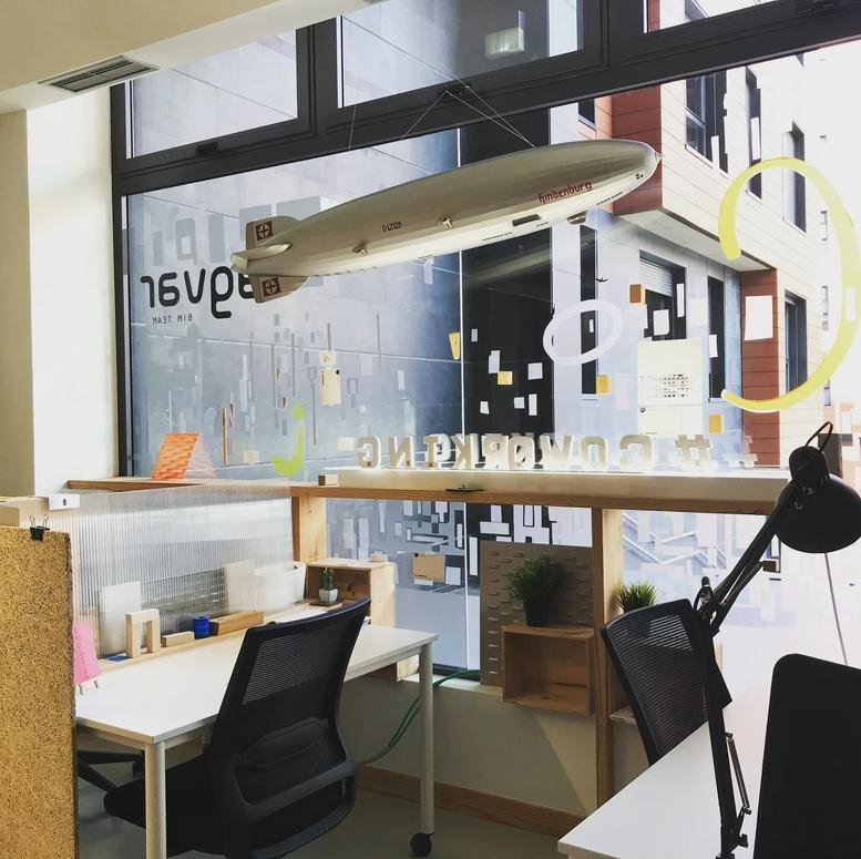 Modern office at Calle Quintana 4, Plaza del Gas, Bilbao with large windows and a model blimp.