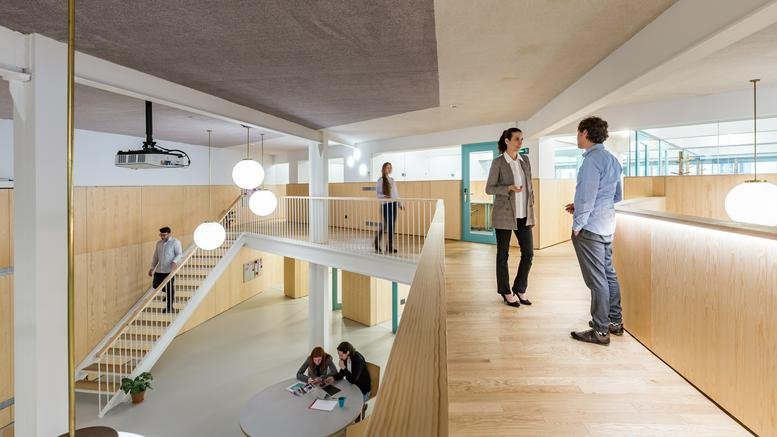 Spacious communal coworking area at Calle Serrano Anguita, 13, Alonso Martínez, Madrid, Spain with mezzanine levels.