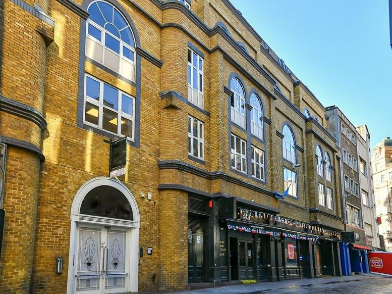 Exterior view of the yellow brick facade at Cameo House, 11 Bear Street, London.