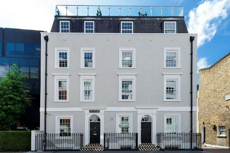 Exterior view of the white facade and dark mansard roof of Carlyle House, 235-237 Vauxhall Bridge Road.