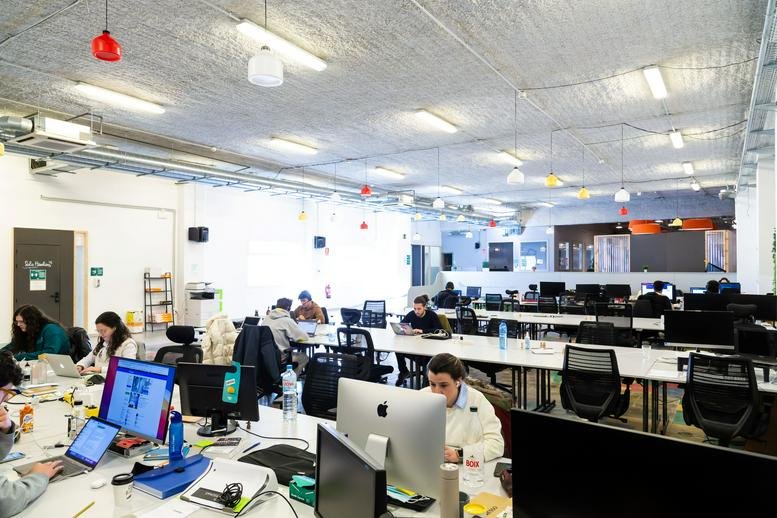 Spacious open-plan workspace at Carrer del Sol 62 with industrial ceilings and natural light.