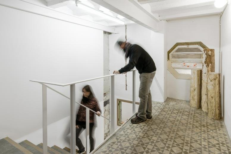 Spacious communal area at Carrer Poeta Cabanyes, 58, Barcelona with high ceilings, stairs, and natural light.