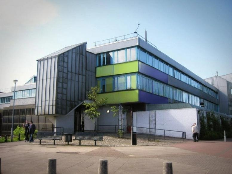 Exterior of Carron House, Carron Way, Cumbernauld featuring a modern facade with lime green and purple panels.