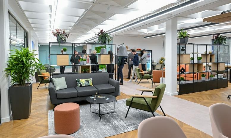 Spacious communal lounge at Castle Park, Cambridge with modern sofas, potted plants, and natural light.