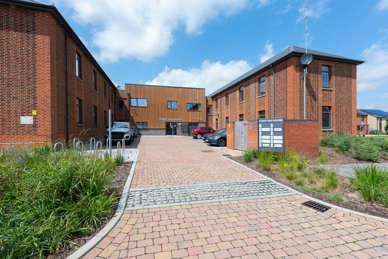 Exterior brick facade and paved courtyard at Challenger Place, Bordon, Hampshire.