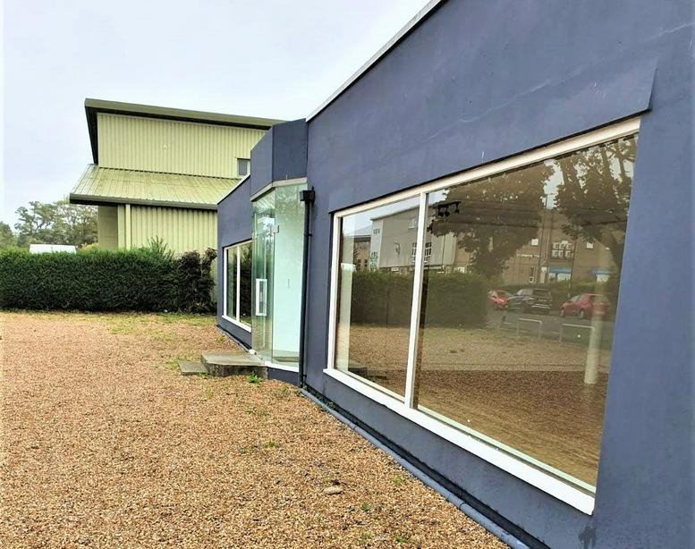 Exterior view of the modern blue-facade building at Unit 26B/28 Terminus Road.