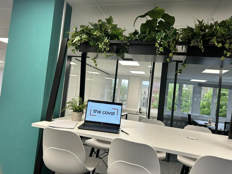High-top coworking desk with plants and a laptop at Civic Centre, Duke Street, Chelmsford, Essex.