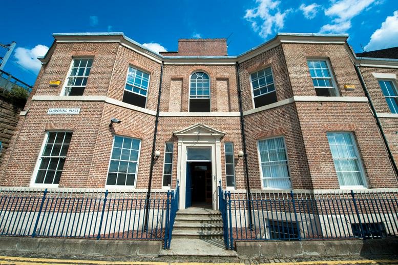 Exterior view of the historic red brick facade at Clavering House Business Centre.