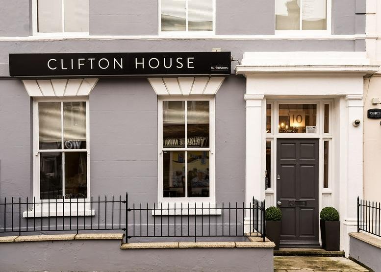 Exterior view of the grey facade and classic entrance of Clifton House.