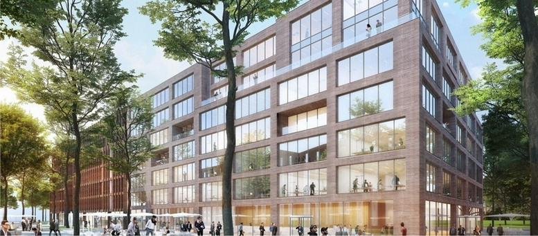 Exterior view of the brick and glass Cable warehouse 11 building surrounded by green trees.