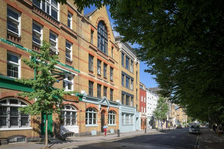 Exterior brick facade of Connolly Works, 41-43 Chalton Street featuring large arched windows.