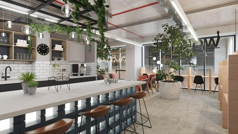 Spacious communal breakout area with plants and kitchen at Core, Brown Street, Manchester.